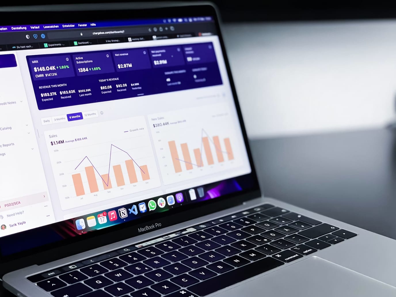 A revenue dashboard open on a laptop, showing recurring revenue and sales charts